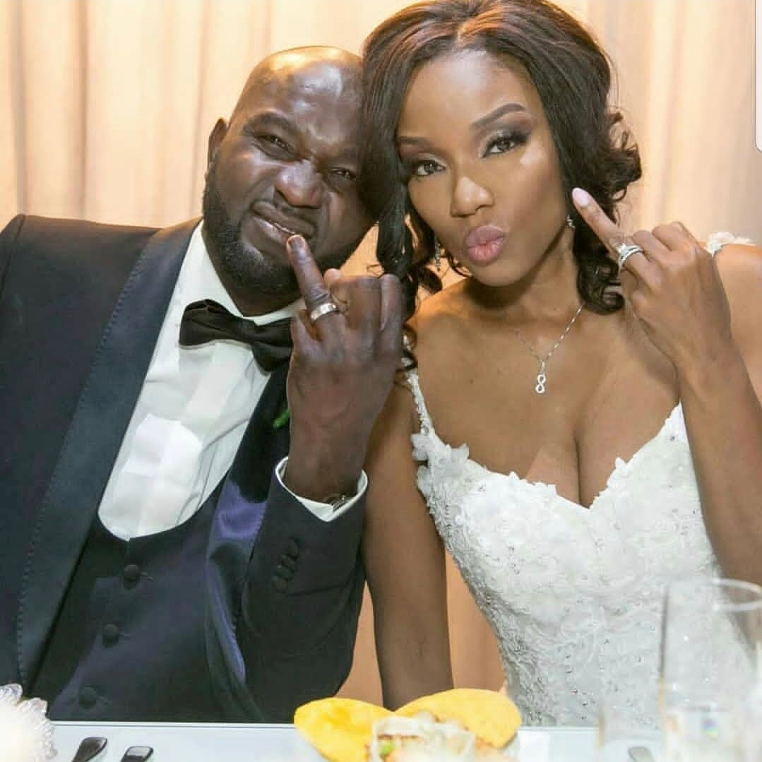 Smiling couple celebrating their engagement, with a focus on the woman's custom engagement ring.