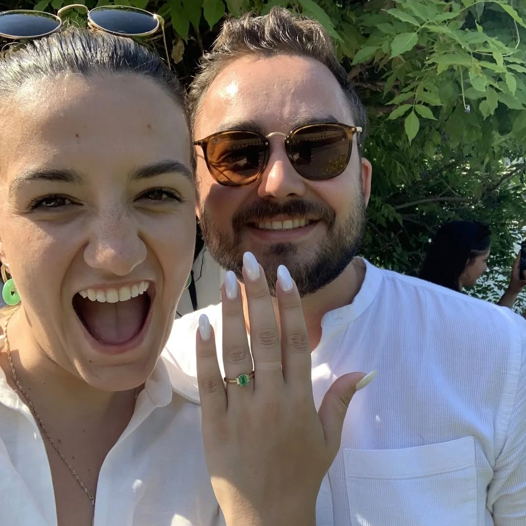 A thrilled customer showcasing their custom-designed engagement ring designed by Design by Sevan