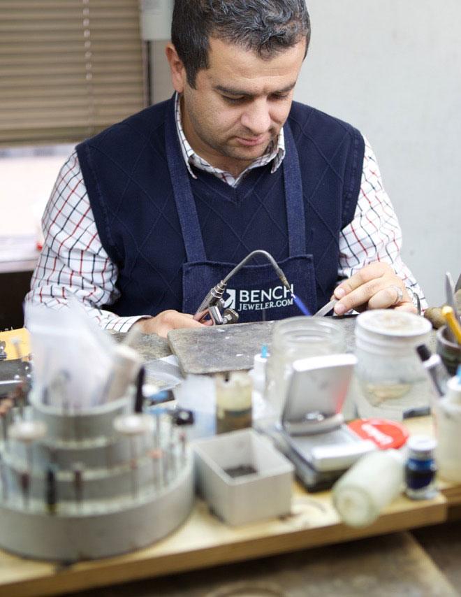 Close-up of a custom engagement ring being polished at Design by Sevan's workshop